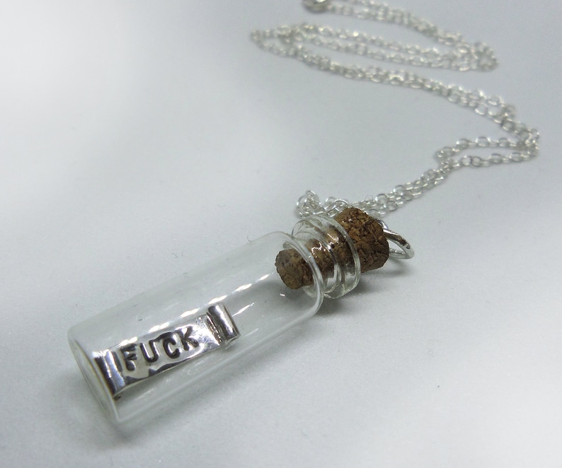 Tiny real glass bottle pendant with a handmade mini small tiny silver scroll with curled ends with the word FUCK engraved on both sides, inside the bottle that moves freely, cork top attached to an 18" chain 'My last fuck given' 'dont give a fuck'