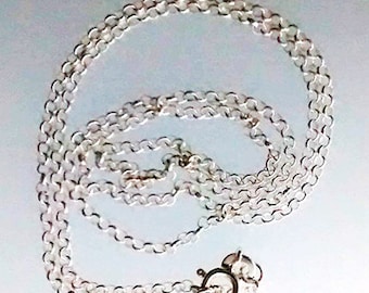 May include: A silver chain necklace with a lobster clasp closure.