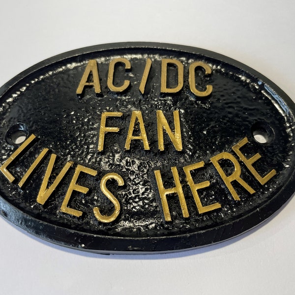 AC-DC Fan Lives Here Home or Garden Wall Sign in Black with Gold Raised Lettering