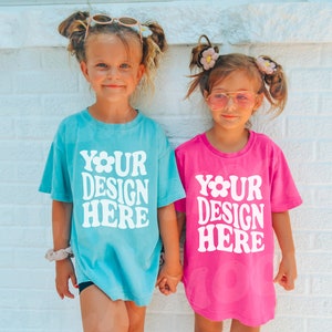 Kids Comfort Colors C9018 Youth Crunchberry Lagoon Blue Sibling T-Shirt Mockup Models Sister Girl Oversized Pink SVG Mock Outdoor Printify