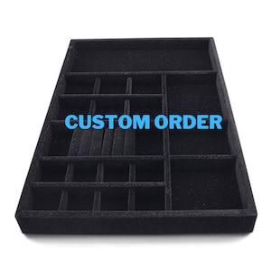 May include: Black velvet jewelry tray with multiple compartments for storing rings, earrings, and other small items. The tray has the words "CUSTOM ORDER" printed on it.