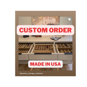 May include: A custom jewelry storage unit with multiple open drawers. The drawers are filled with various jewelry pieces. The text "CUSTOM ORDER" and "MADE IN USA" are displayed on the image.