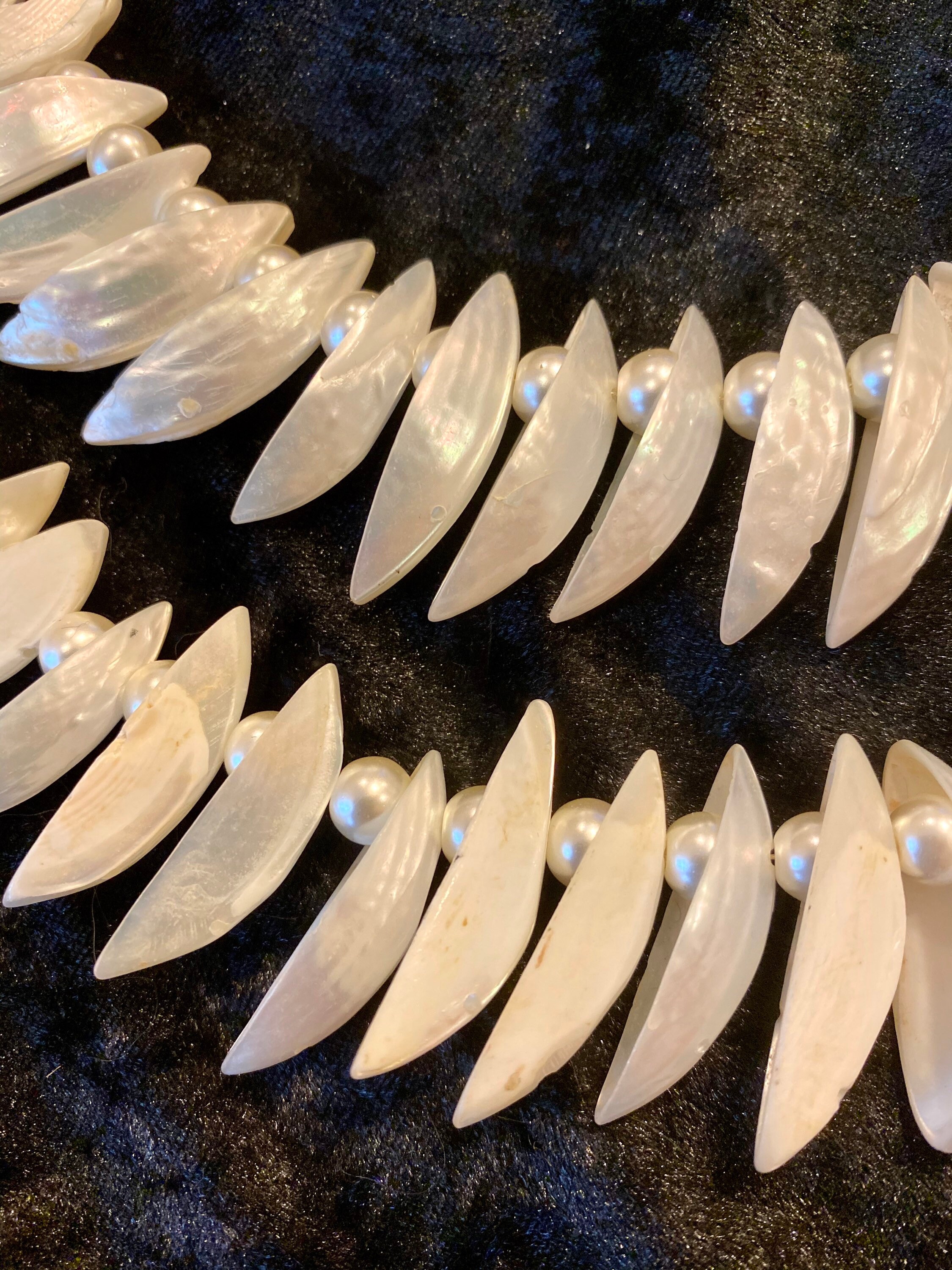 Mother of Pearl shells strung with pearls and hang from a gold Etsy