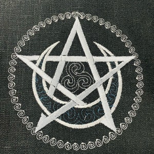 May include: A white pentagram with a triple moon symbol inside, surrounded by a white circle with a decorative border. The design is embroidered on a dark gray fabric.