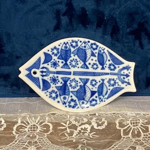 May include: A set of three ceramic mugs with a speckled, matte finish. The mugs are in shades of cream, light gray, and dark gray. Each mug has a simple, minimalist design, perfect for coffee or tea.