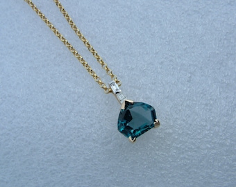 Blue Topaz and diamond pendant.