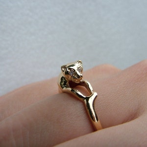 Panther ring-Gold Panther ring with diamonds-Panther relaxing with diamond set eyes in 10 carat yellow golg