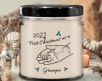 First Christmas Grampa candle 2023, baby holding finger, hands, holly