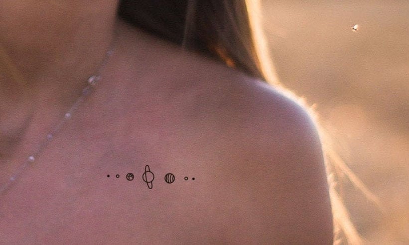 Minimalistic universe tattooed on the wrist.