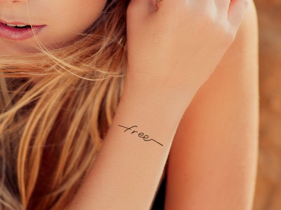 freedom tattoo on wrist
