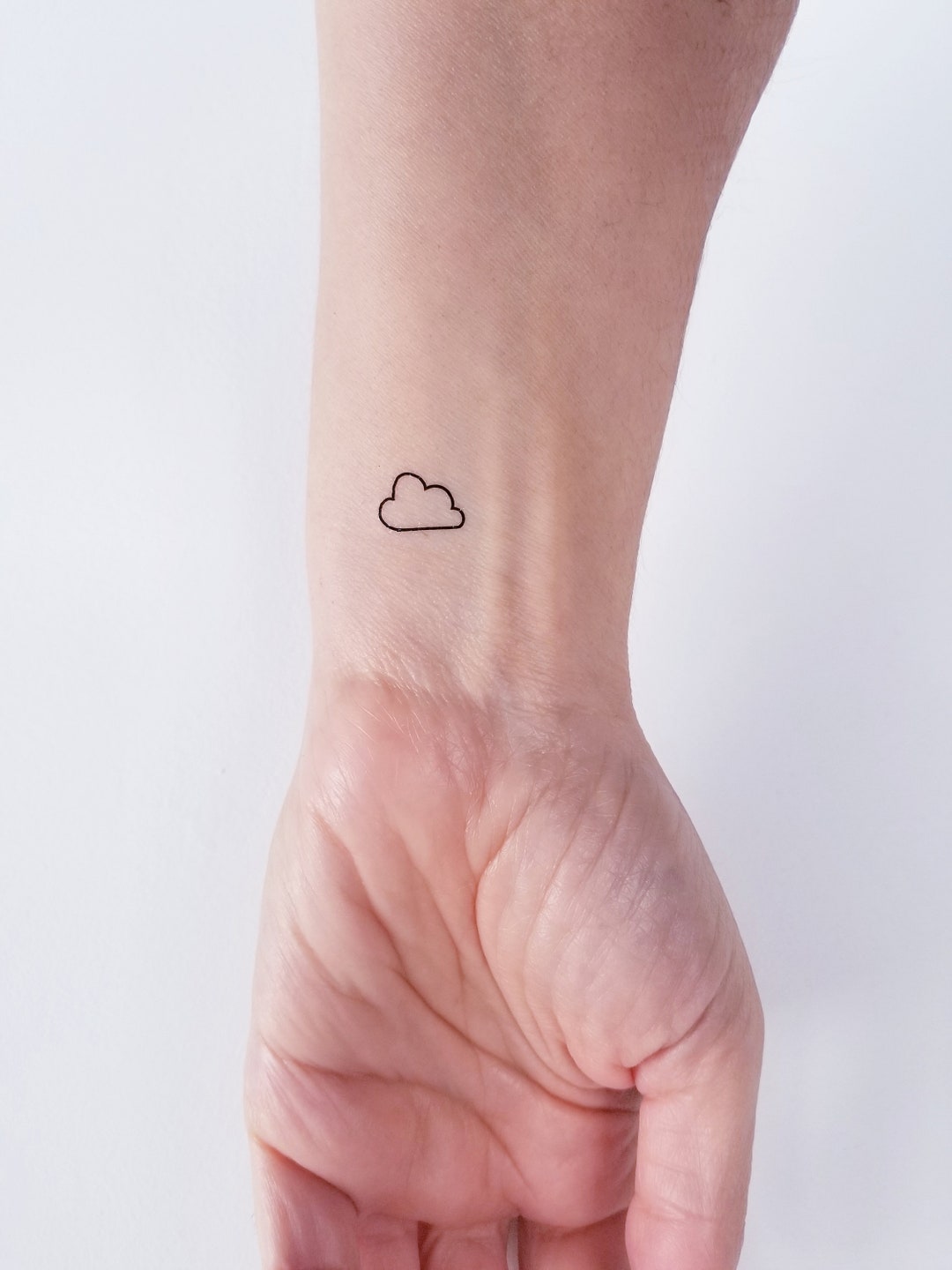 pastel blue Japanese cloud tattoo on arm on Craiyon