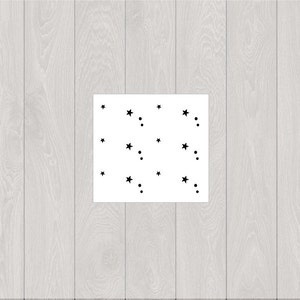 May include: A white background with black stars and dots scattered across the surface.