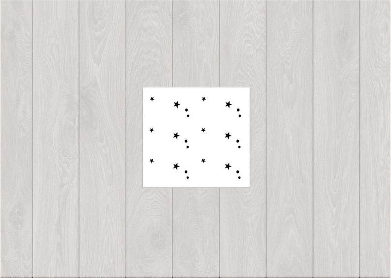 May include: A white background with black stars and dots scattered across the surface.