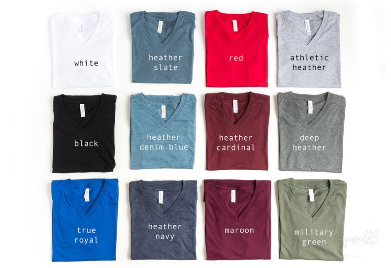 May include: A collection of 12 V-neck t-shirts in various colors, including white, black, heather slate, heather denim blue, heather cardinal, deep heather, true royal, heather navy, maroon, and military green. Each shirt has a different color and is labeled with its color name.