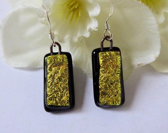 Gold/black dichroic glass earrings. Sterling silver fused glass earrings with textured gold pattern on a black background.