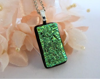 Pale green and black dichroic glass pendant with a textured pattern. Green-black fused glass necklace. Shiny lime green glass pendant.