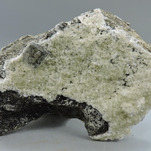 Stilbite with a single calcite crystal from New Jersey – cabinet size
