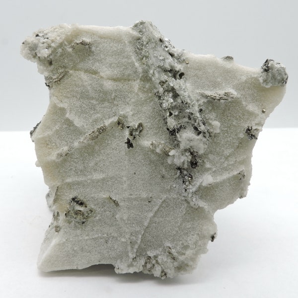 Scapolite (partly pseudomorphosed) and pyrite in saccharoïde gypsum from France – miniature