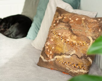 Earthy brown pillow case with bright orange accents