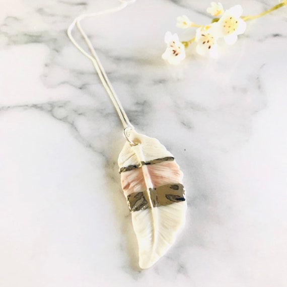 Pink feather pendant with platinum stripe on a sterling silver chain