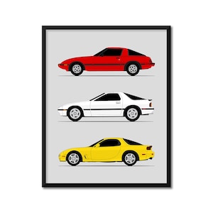 May include: A framed print featuring three classic sports cars in red, white, and yellow. Each car is depicted in a side profile, showcasing their sleek design and distinct features. The cars are set against a light gray background.