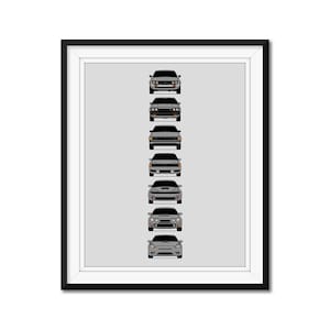 May include: Framed print showing seven grey sports cars in a vertical row, each with a distinct design, set against a light grey backdrop. The cars are viewed from the front, highlighting their headlights and grilles.