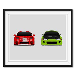 May include: Framed print featuring two stylized sports cars. One is red with white accents and the text "GT". The other is green with a black hood. Both cars are depicted head-on against a light gray background.