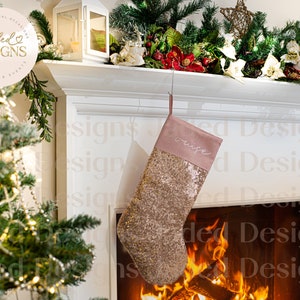 May include: A gold sequin Christmas stocking with a pink velvet cuff and the word "wife" embroidered on it. The stocking is hanging from a fireplace mantel with a roaring fire in the fireplace.