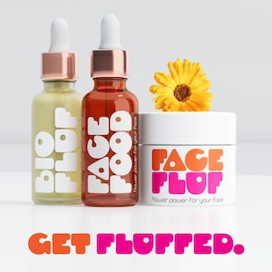 May include: A skincare product display featuring two glass dropper bottles and a white jar. The bottles have white text that reads "BIO PLOP" and "FACE FOOD". The jar reads "FACE FLUFF". A yellow flower sits atop the jar. The phrase "GET FLOFFED" is at the bottom.