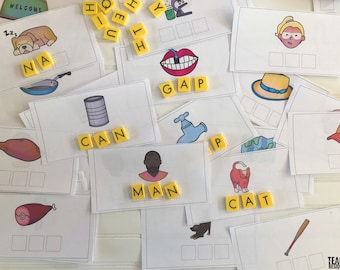 May include: A set of yellow letter tiles with images of various objects, such as a cat, a dog, a can, a man, a hat, and a baseball bat. The tiles are arranged in a grid pattern on a white surface. The words spelled out on the tiles are "cat", "can", "man", "gap", "nap", and "hat".