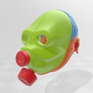 May include: A green, orange, and blue plastic mask with a red mouthpiece. The mask has a rounded shape and a design that resembles a face.