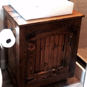 Solid pine vessel sink vanity with a white vessel sink and oil-rubbed bronze faucet in a small bathroom