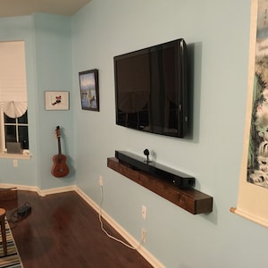 Rustic floating wood shelves with hidden fasteners, TV entertainment center