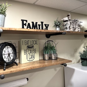 Rustic farmhouse pipe mounted wood shelves from an angle, with a paper towel holder (a custom option)