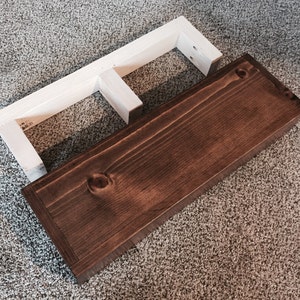 Rustic floating shelf beside its wall cleat, which screws to the wall and hides inside the shelf