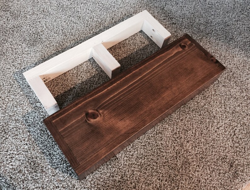 Rustic floating shelf beside its wall cleat, which screws to the wall and hides inside the shelf