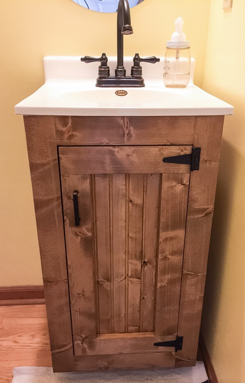 Front view of the small pine vanity with a beadboard door, magnetic closure and oil-rubbed bronze T-hinges