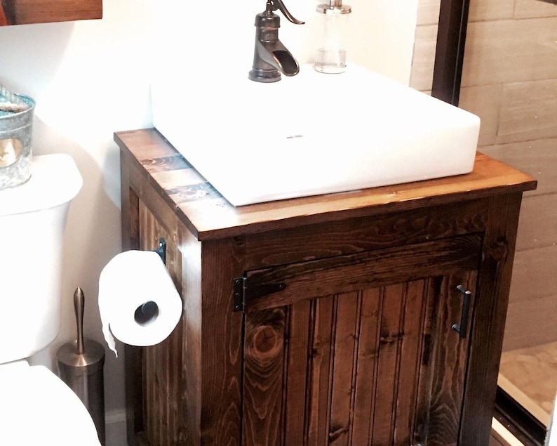 Rustic vessel sink vanity in dark walnut stain with a white vessel sink, planked pine top and oil-rubbed bronze hinges