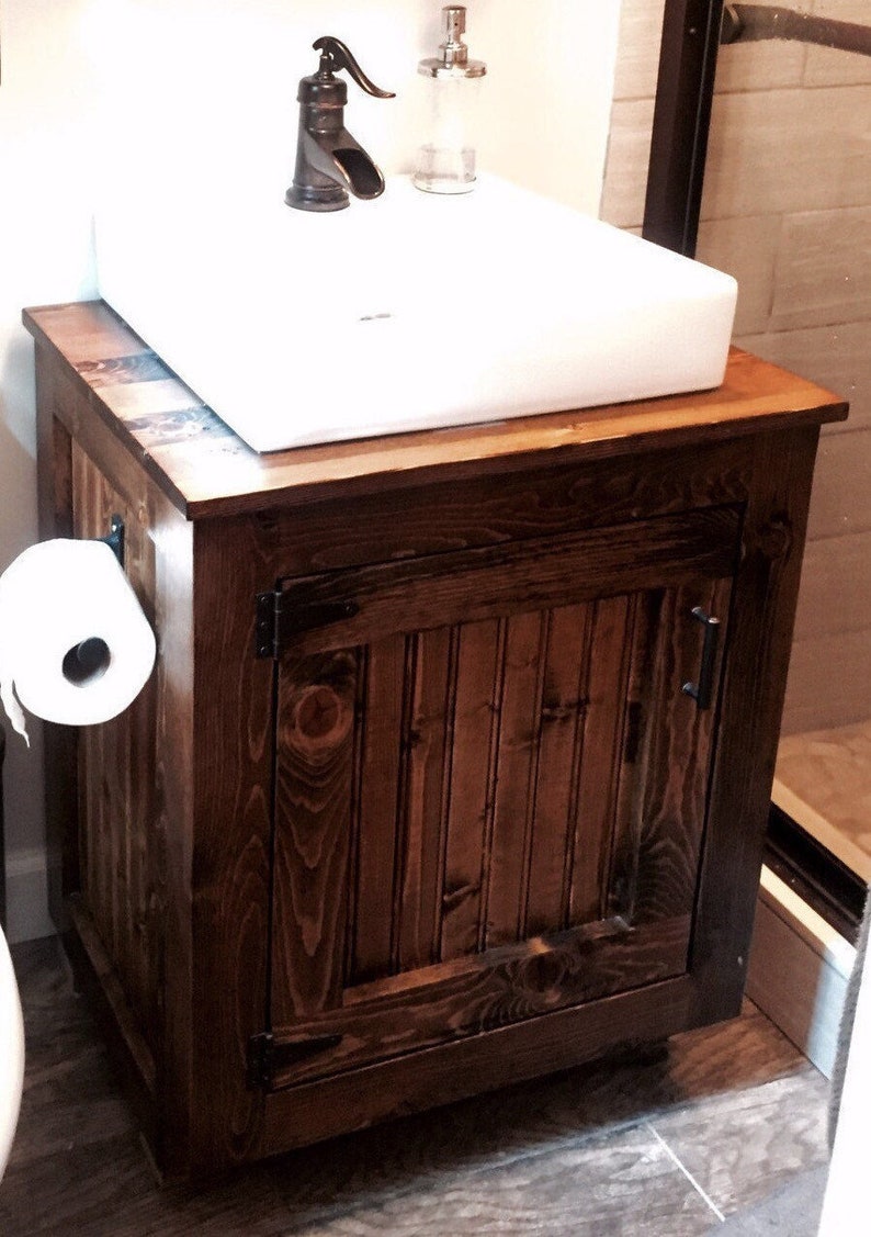 Solid pine vessel sink vanity with a white vessel sink and oil-rubbed bronze faucet in a small bathroom