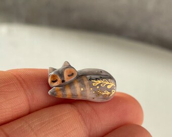 Miniature porcelain cat pin decorated with gold