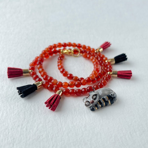 Lucky charm red colar with carnelian beads and porcelain racoon