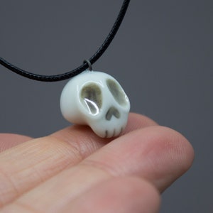 Porcelain miniature white skull pendant decorated with 22k gold