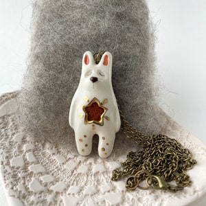 Ceramic rabbit essential oil diffuser necklace with gold details and a star