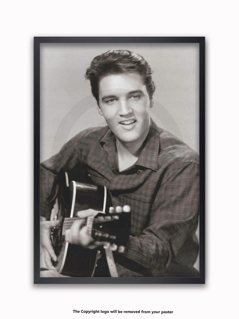 May include: Framed black and white poster of a man playing a guitar. The man is smiling and wearing a plaid shirt. The poster is in a black frame with a white background.