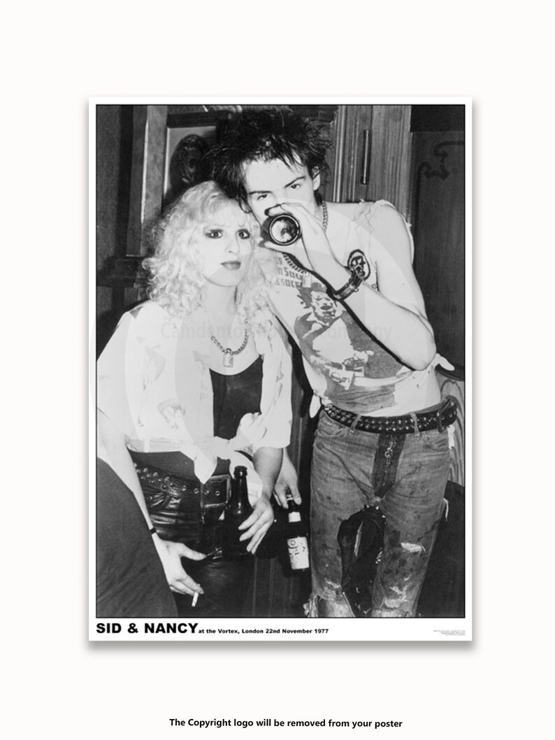 May include: Black and white photo of a couple, Sid and Nancy, at the Vortex in London on November 22, 1977.  Sid is wearing a t-shirt, jeans, and a belt with studs. Nancy is wearing a white shirt, black leather pants, and a necklace.