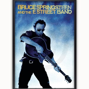 May include: A black and white poster featuring Bruce Springsteen and the E Street Band. The poster has a blue background with a white silhouette of Bruce Springsteen playing a guitar.