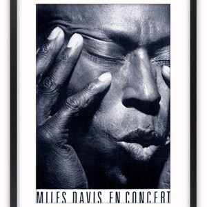 May include: A black and white photo of Miles Davis, a famous jazz musician, with his eyes closed and his hand on his face. The text "MILES DAVIS IN CONCERT" is at the bottom of the photo.