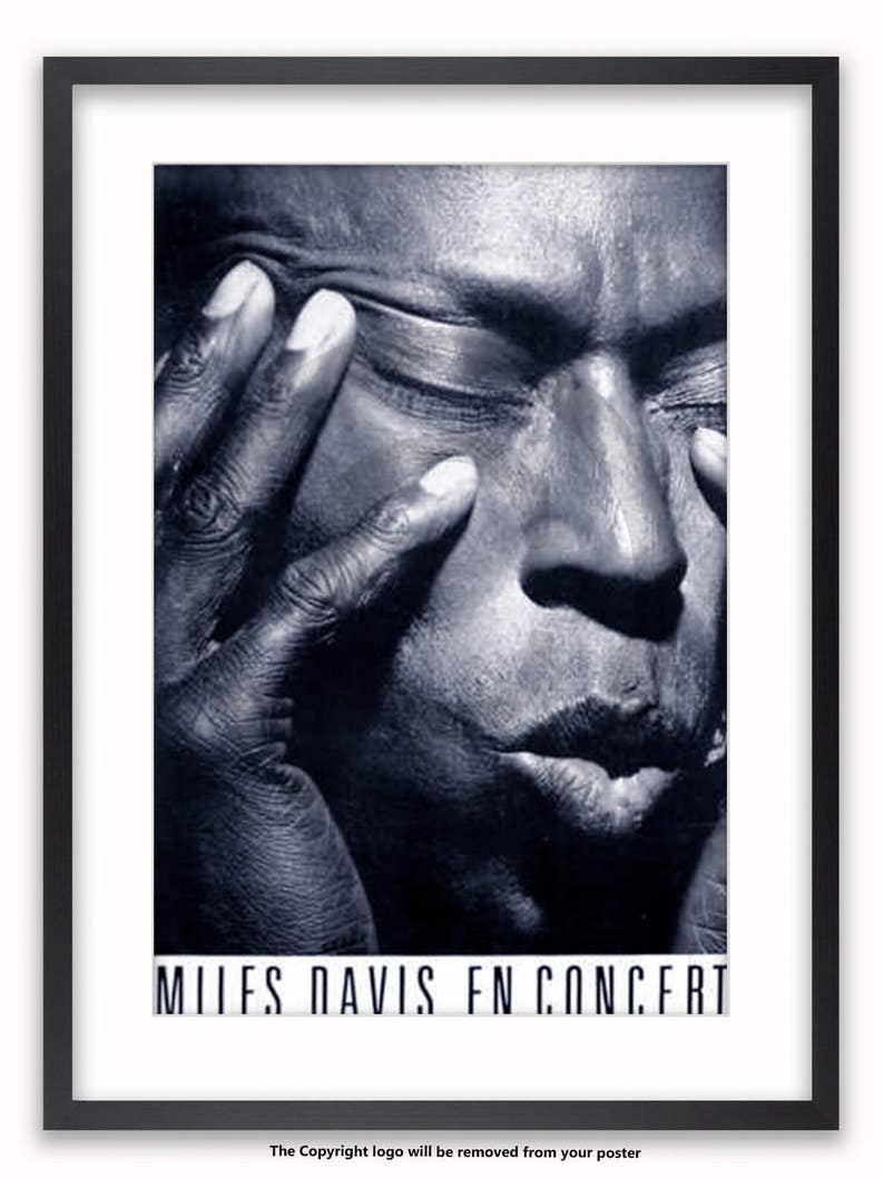 May include: A black and white photo of Miles Davis, a famous jazz musician, with his eyes closed and his hand on his face. The text "MILES DAVIS IN CONCERT" is at the bottom of the photo.