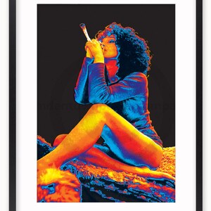 May include: A woman with curly hair sits on a rug, wearing a blue shirt and holding a lit cigarette. The image is in a thermal colour palette, with shades of red, orange, yellow, and blue.
