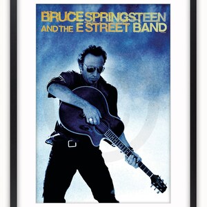 May include: A blue and white poster featuring Bruce Springsteen and the E Street Band. The poster features a photo of Bruce Springsteen playing a guitar.